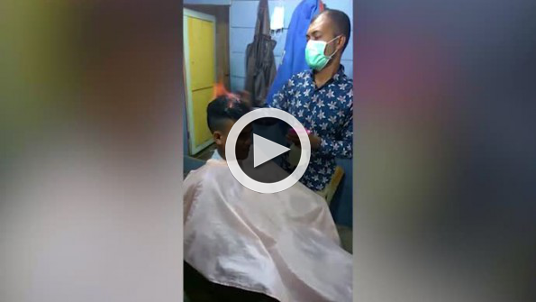 Saçı yakarak traş eden kuaför görenleri hayrete düşürüyor
